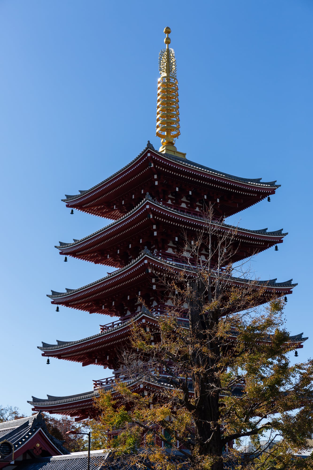 O pagode de cinco andares em Senso-ji se eleva acima dos telhados do templo em camadas